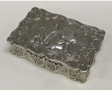 A Victorian Dutch silver chased silver hinged snuff box bearing import marks. Approx. 139 grams. Est. £100 - £150.
