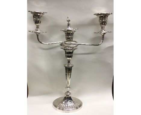 A heavy silver three branch candelabra of tapering form with fluted swirl effect branches. Sheffield. By JD&amp;S. Approx. 64