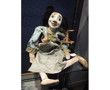 AN EASTERN PUPPET with white painted face and articulated limbs and hands