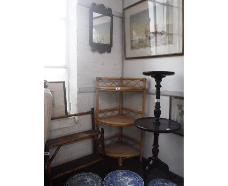 A GEORGE III MAHOGANY WALL MIRROR with scrolling crest, a reproduction dumb waiter, a Victorian bamboo shelf and another bamb