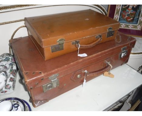 A VINTAGE LEATHER SUITCASE and a similar briefcase