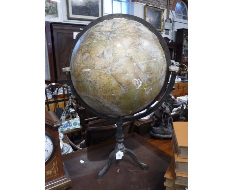 A TERRESTRIAL GLOBE ON STAND: The globe surface with a number of applied patches, with a graduated brass ring on a cast-iron 