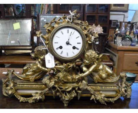A 19TH CENTURY FRENCH ORMOLU CASED MANTEL CLOCK, decorated with cherubs, the white enamel movement inscribed 'THO PEARCE & SO