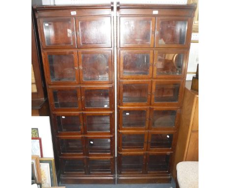 A PAIR OF GLOBE-WERNICKE STYLE MAHOGANY SECTIONAL BOOKCASES each section with double doors 24" wide x 69.5" high