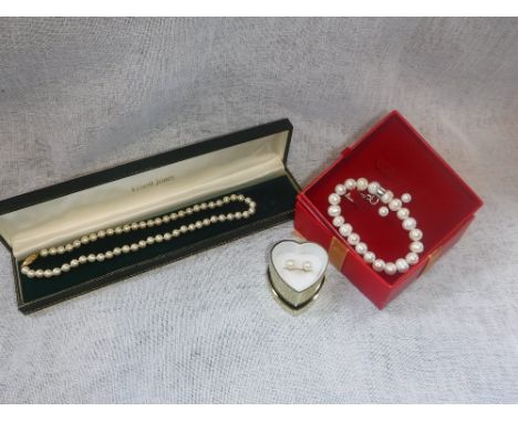 A SINGLE STRAND CULTURED PEARL NECKLACE, a pair of similar earrings and a bracelet (3)