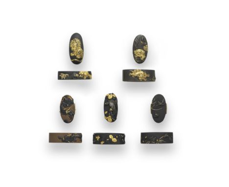 FIVE FUCHI-GASHIRA (HILT COLLARS AND POMMELS)Edo period (1615-1868), 19th centuryThe first shakudo nanako, chiselled in relie