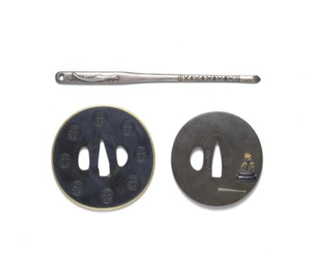 TWO TSUBA (HAND GUARDS) AND A KOGAI (SKEWER)Edo period (1615-1868), early/mid-19th centuryThe first tsuba shakudo, circular, 