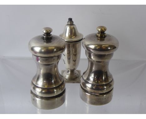 A Silver Hallmark Salt and Pepper Grinder, London hallmark, dated 1979, mm MCH together with a silver salt. (3)