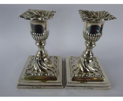 A Pair of Silver Candle Sticks, Sheffield hallmark dated 1893, mm Henry Wilkinson & Co., the candle sticks having a ribbed bo