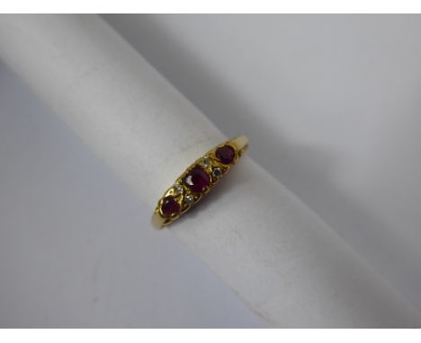 A Lady's Antique 18 ct Yellow Gold Ruby & Diamond Ring, the ring set with three rubies and four old cut diamonds, 4 x 1pt 8 c