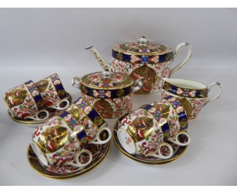 A Part 19th Century Crown Derby Imari Pattern Tea Set, hand painted gilded comprising of tea pot, sugar caddy, milk jug, six 