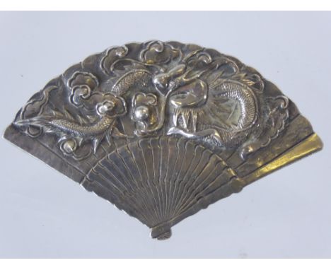 A Chinese Wang Hing Silver Clip, in the form of a fan, carved with chasing dragons amongst cloud scroll, approx 7 x 4.5 cms, 