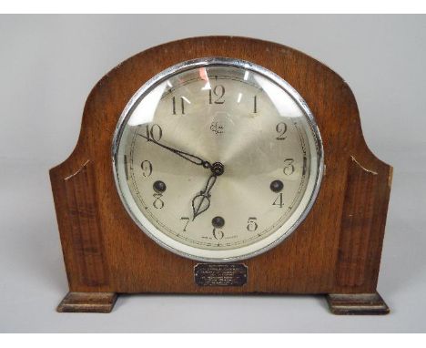 An Enfield Royal mantel clock, Arabic numerals to the dial, movement marked 'Made in England', with pendulum.