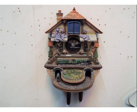 A 'Flying Scotsman' cuckoo clock, with weights.