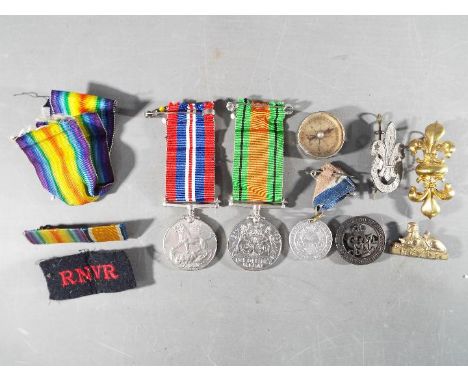 A WWII medal pair comprising  Defence Medal and War Medal 1939-1945 along with a Silver War Badge, numbered 197976, small Ger