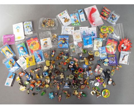 A collection of various pin badges including Noddy, Loony Tunes, Thomas the Tank Engine, Disney, Golly badges and similar.