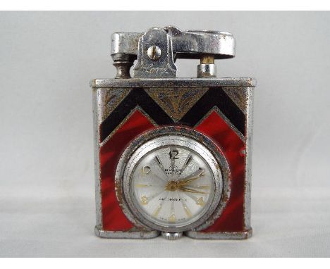 An Art Deco styled desk watch or small travelling clock in the form of a lighter, white metal case with geometric black and f