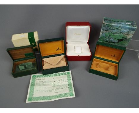 Three vintage Rolex watch boxes, two with outer card boxes, and a Cartier watch box.