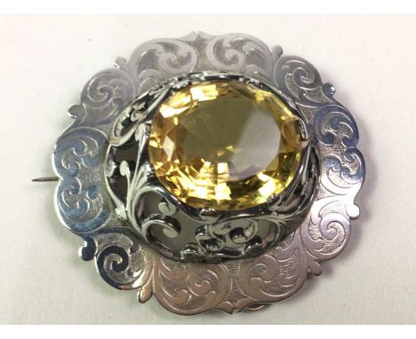 SCOTTISH OVAL BROOCH, with a central quartz stone set in white metal, unmarked, along with a pearl and amethyst set stick pin