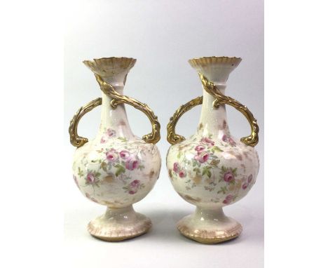 PAIR OF EDWARDIAN CERAMIC VASES, with twin handles and floral decoration on a cream ground30cm high