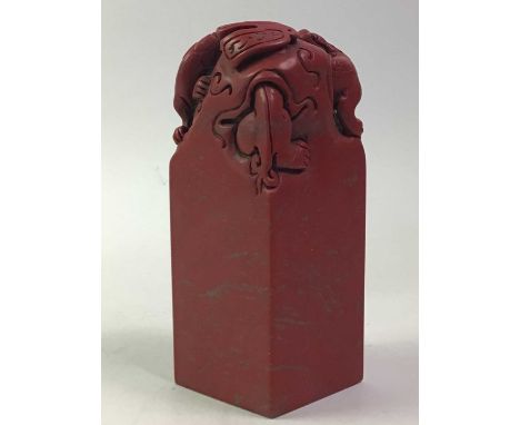 CHINESE RESIN SEAL, 20TH CENTURY the top modelled as mythical creatures, the body bearing Chinese calligraphy, with seal to b