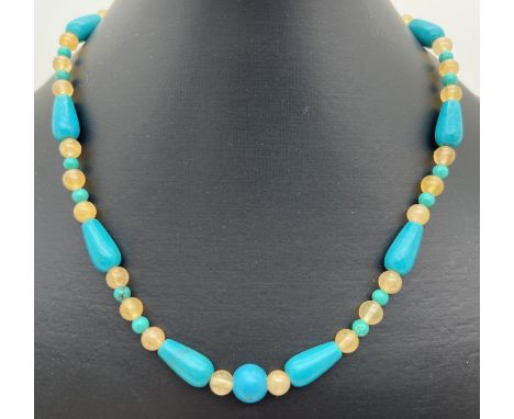 A 16" turquoise and jade beaded necklace of teardrop shaped and spherical beads. With silver tone S shaped clasp. Retired jew