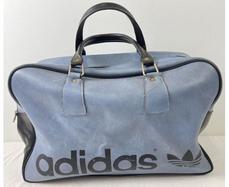 A vintage blue and black classic design Adidas holdall. Adidas name to front with 2 carry handles and zip top. Approx. 42 x 4