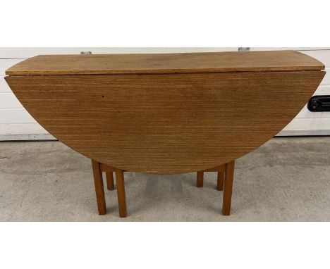A vintage 1970's teak drop leaf slim dining table with gateleg supports. Approx. 74.5cm tall x 122cm long x 34cm deep in fold