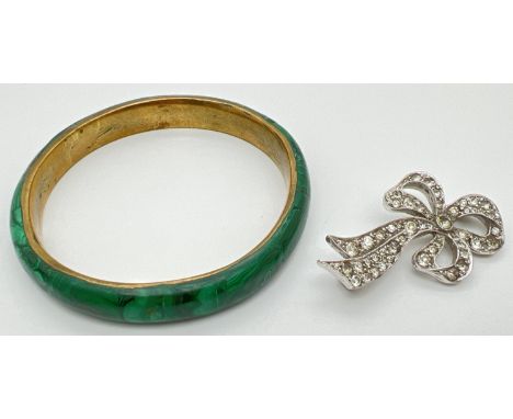 2 items of vintage costume jewellery. A vintage bow brooch set with 50+ round cut clear stones, together with a brass bangle 
