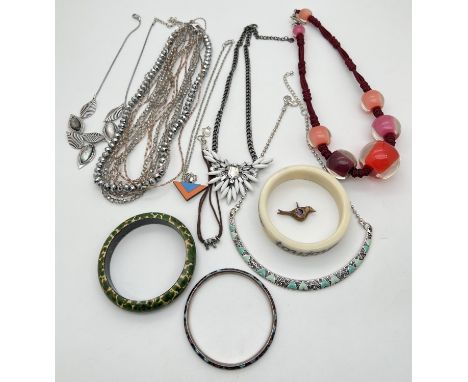 A small collection of costume jewellery necklaces and bangles. To include white metal enamel bangle, multi strand glass bead 