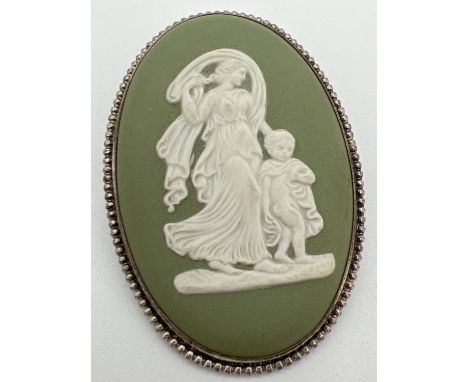 A vintage large oval shaped green Wedgwood brooch in silver rope design mount. Hallmarked London 1977. Classical figures of a