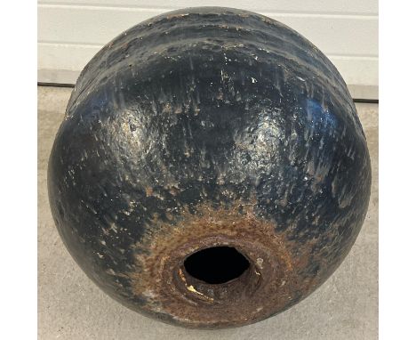 A large vintage cast iron marine bouy, painted black, with hole through the centre. Approx. 53cm diameter. 