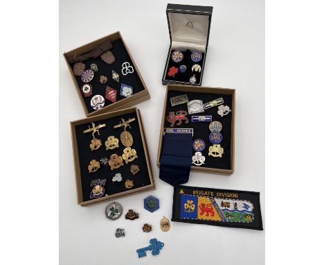 A collection of vintage Girl Guiding brass and enamel badges. Lots includes group leaders ribbon, 10 yr and 20 yr service bad