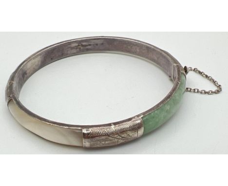 A silver, mother of pearl and jade panel bangle with push clasp &amp; safety chain. Silver mark to clasp. Engraved floral dec