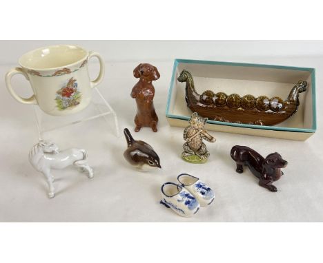 A small collection of vintage ceramics to include Wade, Royal Doulton, Goebel and Beswick. Lot includes boxed Wade Viking bow