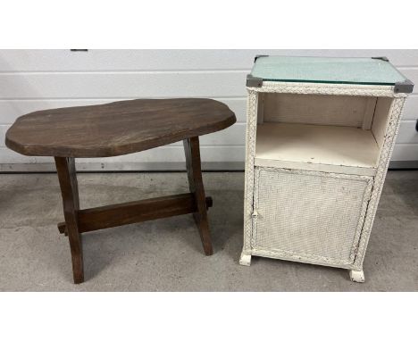 A vintage rustic wooden refectory style side table together with a painted white basket/loom style bedside cabinet with glass