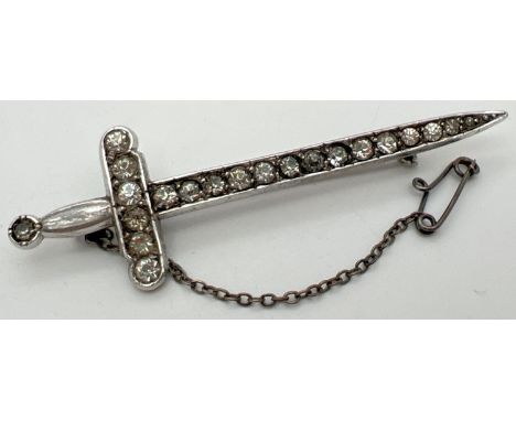 A vintage silver stone set brooch modelled as a sword, complete with safety chain. Set with 20 round cut clear stone. Length 