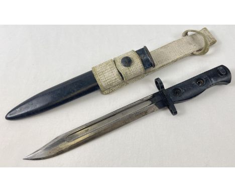 A vintage post WWII L.1.A.4 9600259 Bayonet with scabbard and canvas carry strap. S.M. also stamped to pommel. Length Approx.