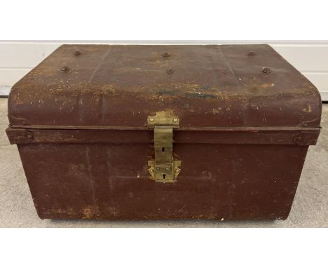 An Edwardian 2 handled tin trunk with original brass catch &amp; lock and studded detail to lid. Brass catch stamped with reg