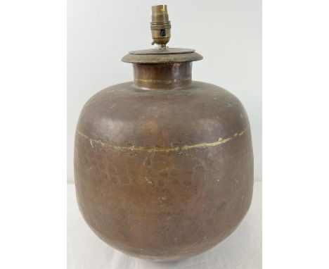 A large vintage brass lamp base of bulbous form with hammered effect. Approx. 42cm tall x 26cm diameter. 