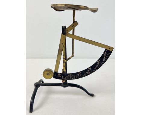 A pair of painted black and brass plated vintage postage scales. Approx. 21cm tall. 