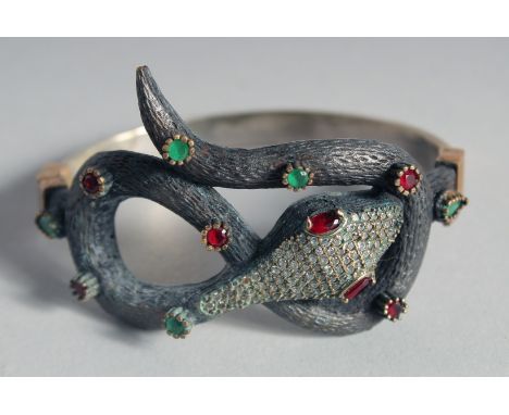 A SILVER AND GILT SNAKE BANGLE, in a heart shaped velvet box.