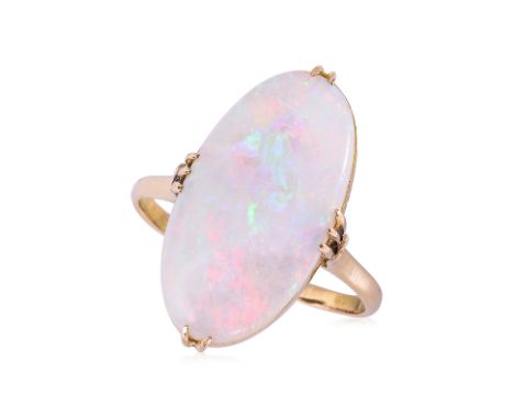 A WHITE OPAL AND YELLOW GOLD RING Featuring a white opal piece weighing approximately 7.00 Cts, mounted in a yellow gold sett