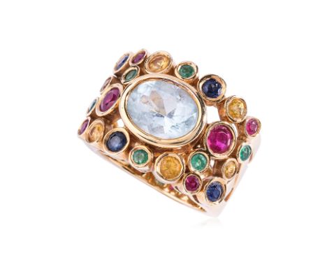 A MULTI-GEM SET RING Featuring multi-gem to include ruby, yellow sapphire, blue sapphire and emerald, centring an oval cut aq