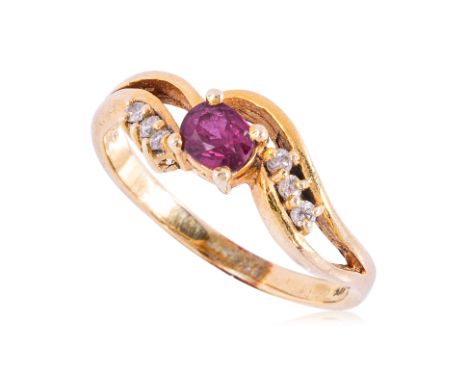 A RUBY AND DIAMOND RING Featuring a cushion cut ruby weighing approximately 0.20 Cts, mounted in a yellow gold setting marked