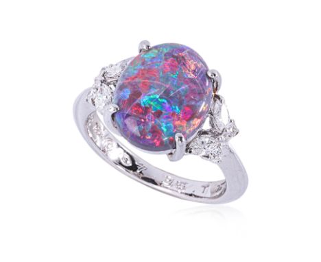 AN OPAL AND DIAMOND RING Featuring a black opal weighing approximately 3.16 Cts (marked), mounted in a platinum setting marke