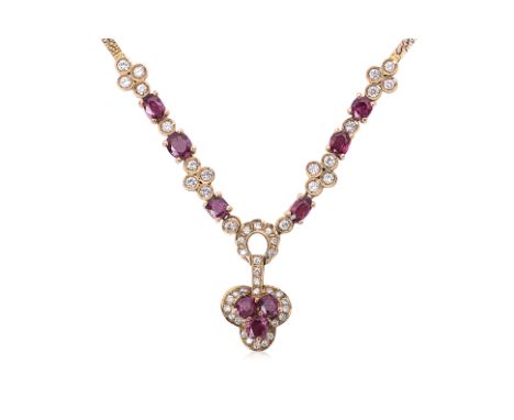 A RUBY AND DIAMOND NECKLACE
Featuring oval and cushion cut rubies totalling approximately 2.20 Cts, mounted in a two tone gol