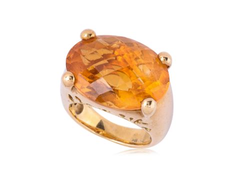 A LARGE CITRINE AND GOLD RING Featuring an oval cut citrine weighing approximately 18.0 Cts, mounted in a yellow gold setting