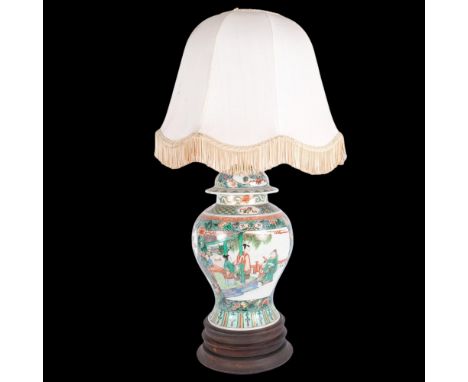 An Oriental ceramic famille vert table lamp, on wooden stand, with figure decorated panels, and shade, H65cm overallNeck of v