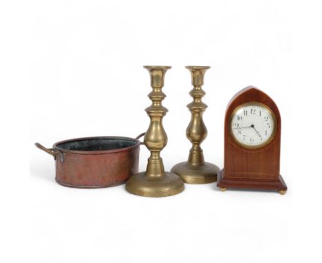 A pair of ornate brass candlesticks, H27cm, a Gothic style mahogany mantel clock, and a copper double-handled pan (4) 